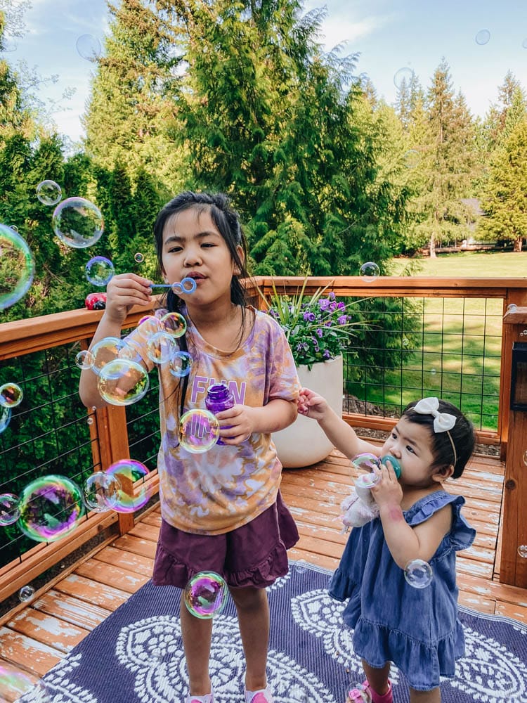 Bubble machines and blowing bubbles is a fun outdoor activity for kids and toddlers.