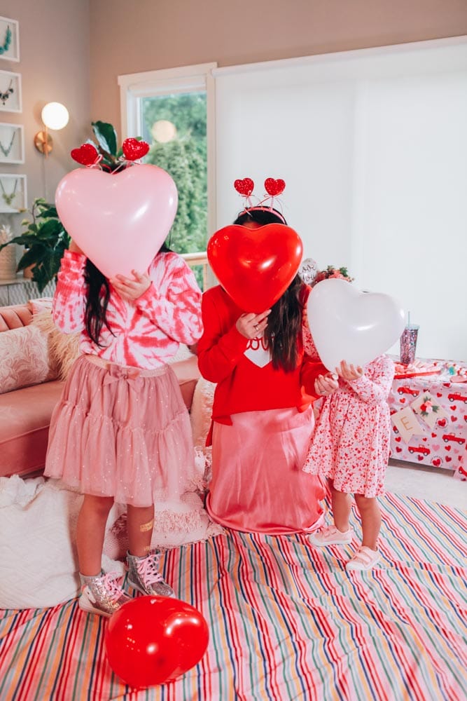 mom and daughter with heart balloons
