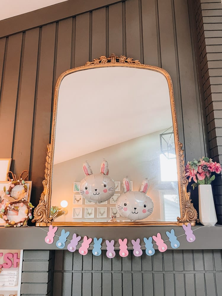 easter decorations over fireplace mantle with large mirror