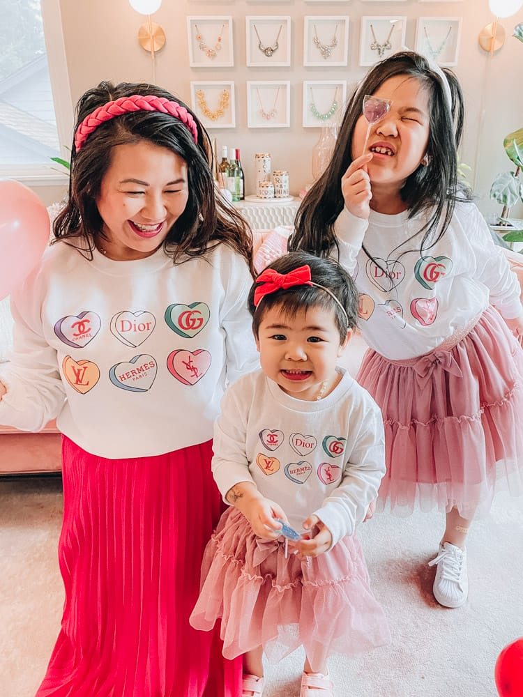 mom and daughters in matching tee shirts and skirts