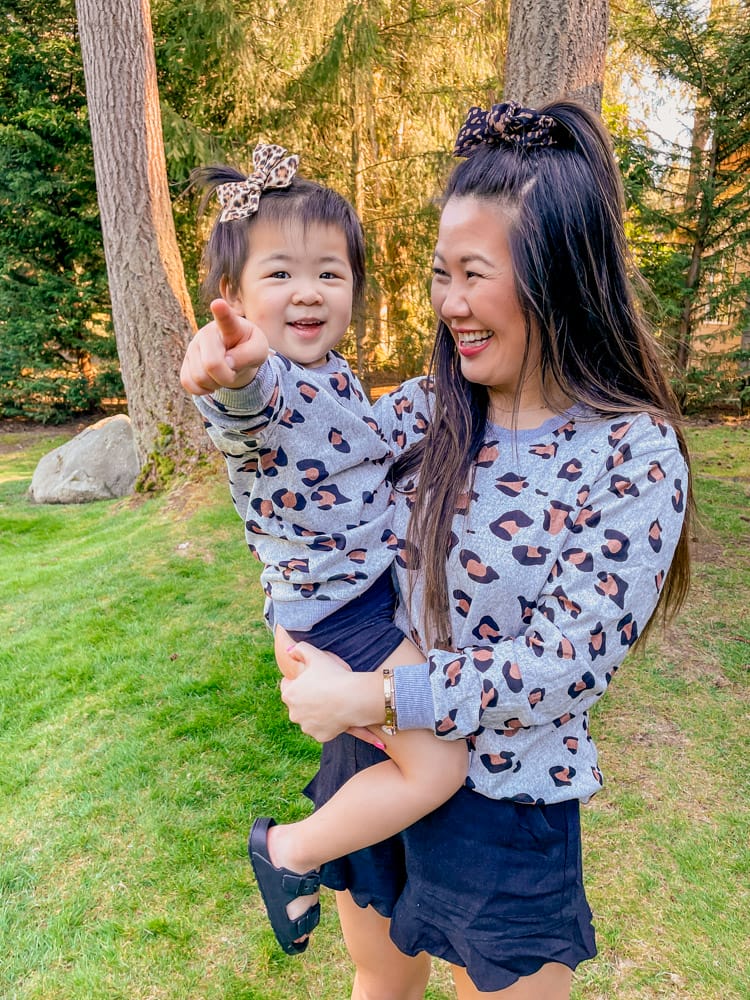 mom and toddler daughter in matching leopard sweatshirts